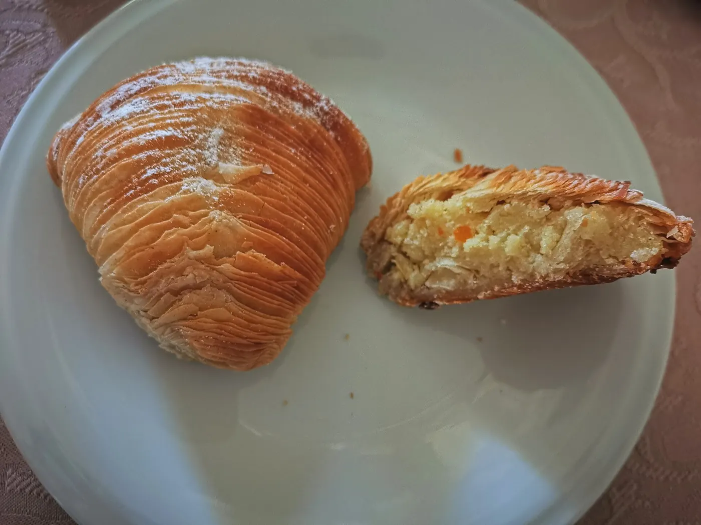 A sfogliatella riccia, cut open to show the ricotta and candied-fruit filling
